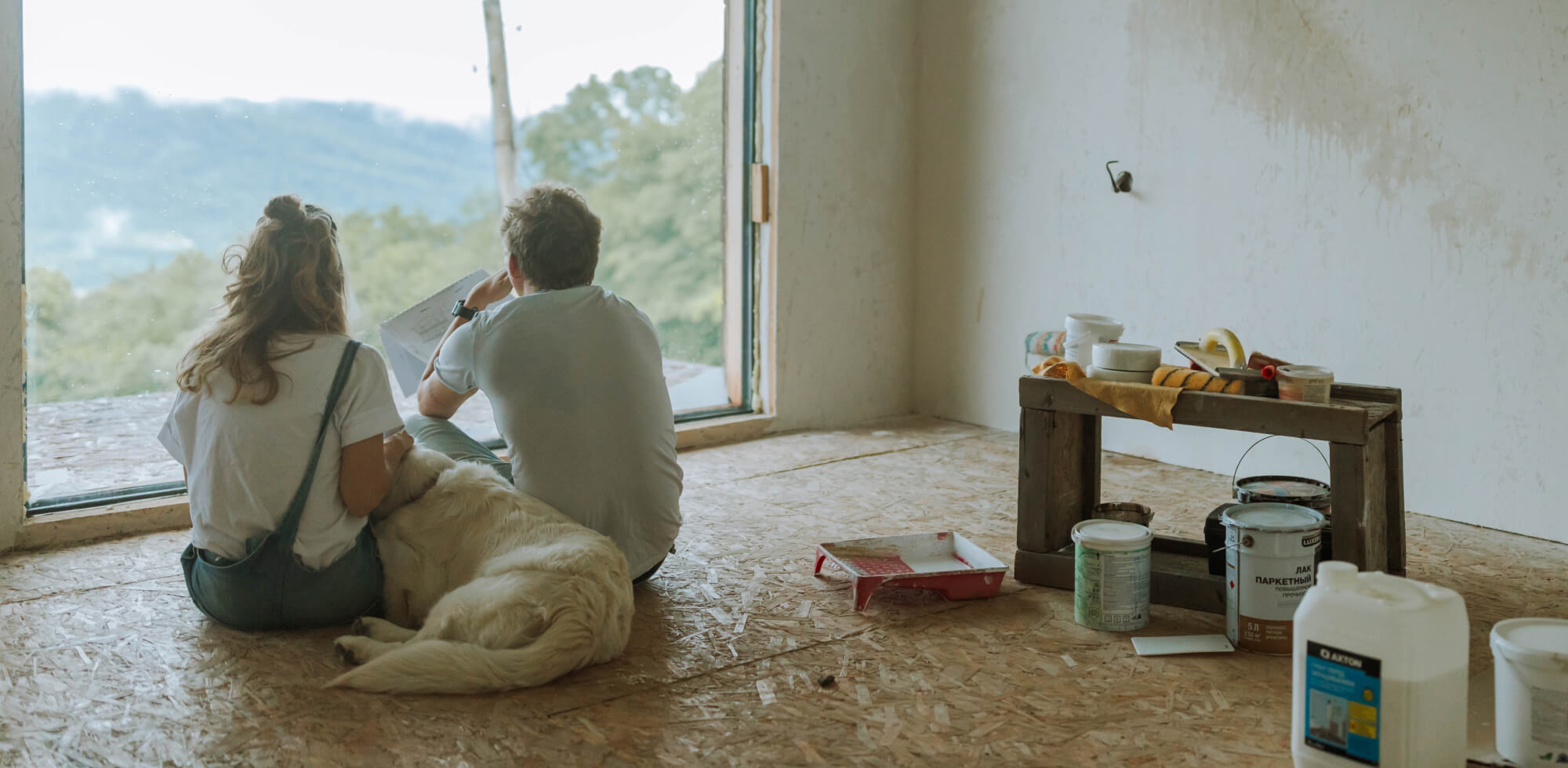 couple and dog taking a break while renovating 